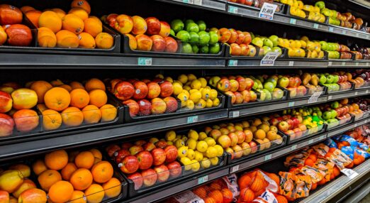 Supermarket shelves with fresh fruit on them