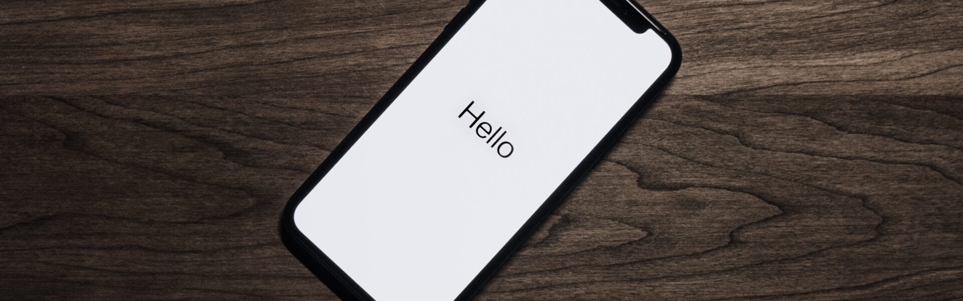 Smartphone on a table with 'hello' on the screen