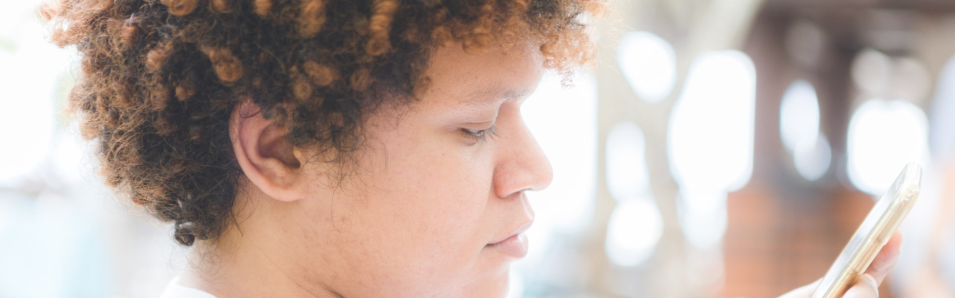 Person looking at a mobile phone screen.